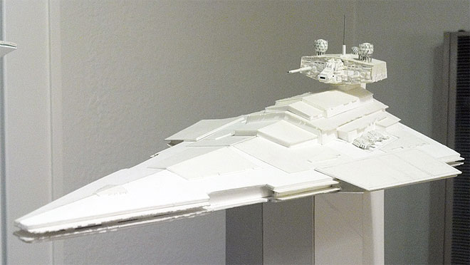 This wedge-shaped Star Wars ship has a massive superstructure and bridge tower (with two symmetrically-placed sensor globes) that are reminiscent of an aircraft carrier. Massive laser turrets flank either side of the superstructure. This view shows the model's current level of completion.